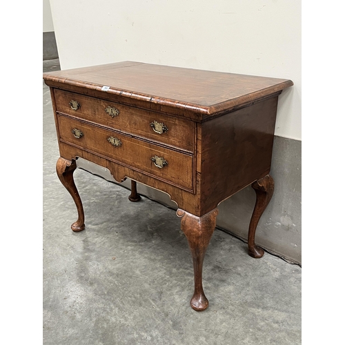 365 - A George II walnut side table, the moulded top crossbanded and line inlaid, over two long line inlai... 