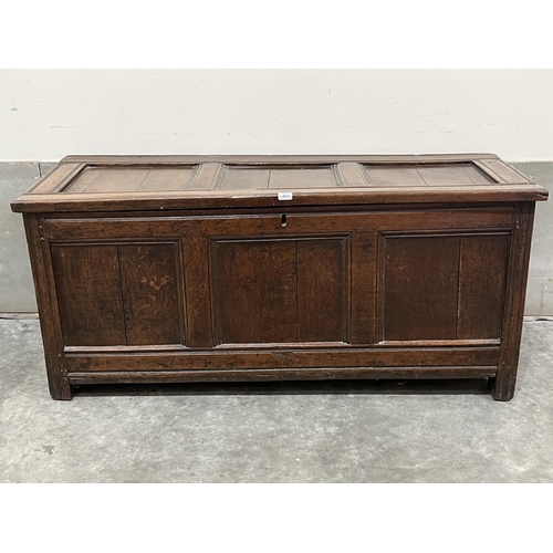 437 - An early 18th century joined oak chest, the three panel fielded lid over conforming front, raised on... 