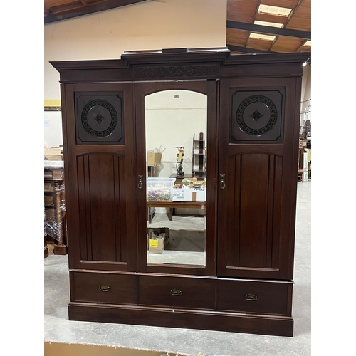 452 - A Victorian mahogany triple wardrobe with three base drawers. 72