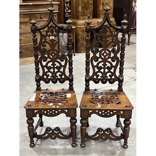 462 - A pair of Victorian gothic oak high back side chairs with tracery carved backs. (A.F.)