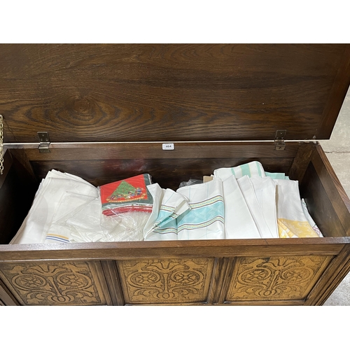 464 - An oak blanket chest and linen contents 45