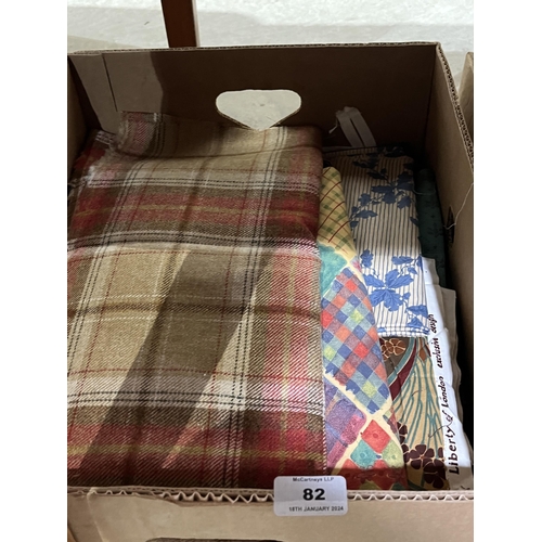 82 - Four boxes of fabric and linen