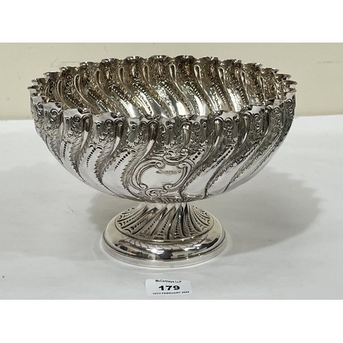 179 - A Victorian wrythen fluted footed bowl, chased with foliage. Sheffield 1888. 9½