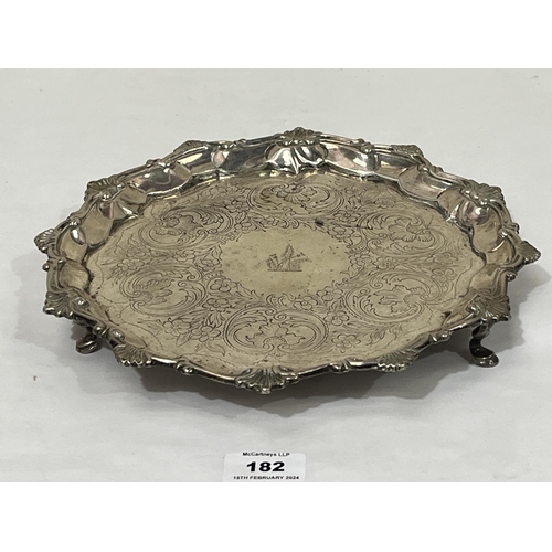 182 - A George III silver salver with shell cast rim and chased decoration of scrolled foliage. London 180... 