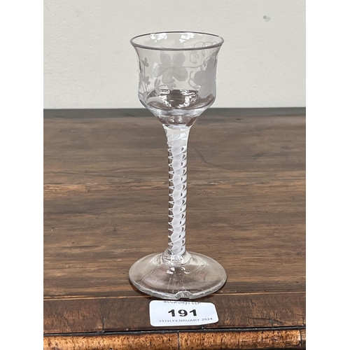 191 - An 18th Century cordial glass, the ogee bowl engraved with vine fruits, on opaque airtwist stem and ... 