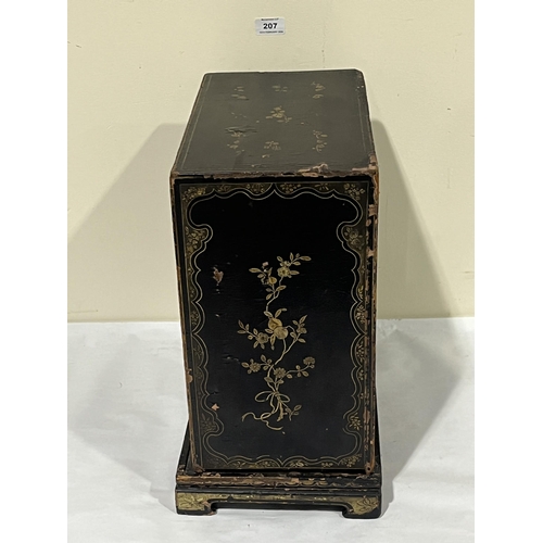 207 - A 19th Century Oriental lacquer table cabinet on stand, decorated with gilt flowers, the pair of doo... 