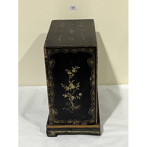 207 - A 19th Century Oriental lacquer table cabinet on stand, decorated with gilt flowers, the pair of doo... 