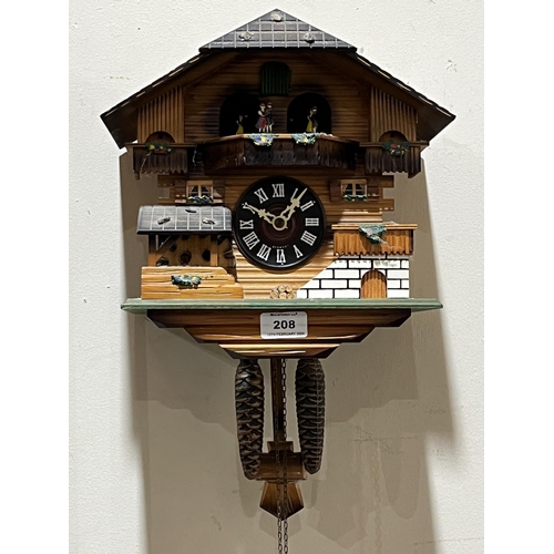 208 - A German cuckoo clock, the two train movement with figure and water wheel automata. 10