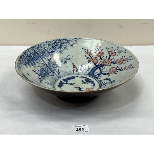 265 - A Chinese bowl, decorated with trees and prunus. 12