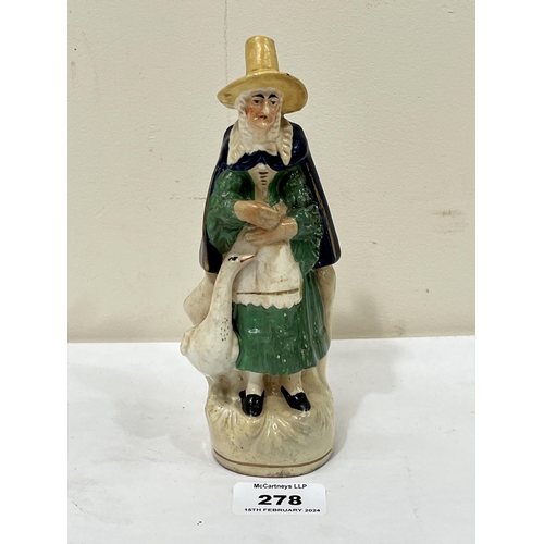 278 - An early 19th Century Staffordshire figure group of Welsh woman with goose. 7¼