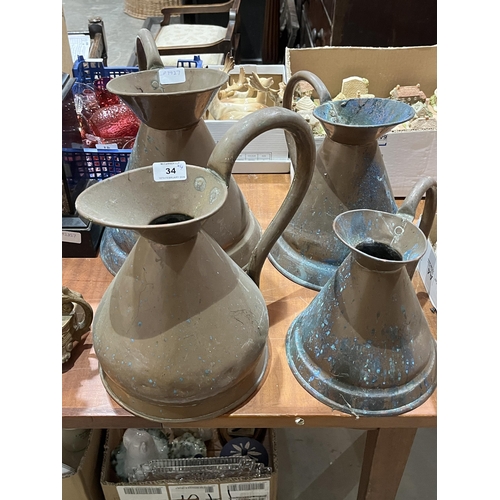 34 - Four copper haystack jugs.