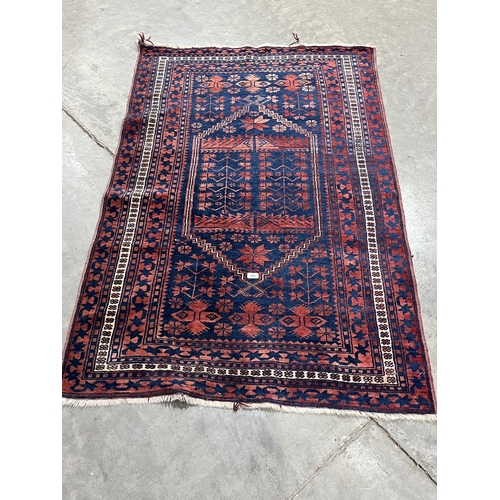 444 - An eastern blue ground rug. 70