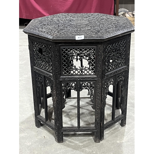 455 - A 19th Century Indian octagonal carved centre table on folding fret pierced base. 23