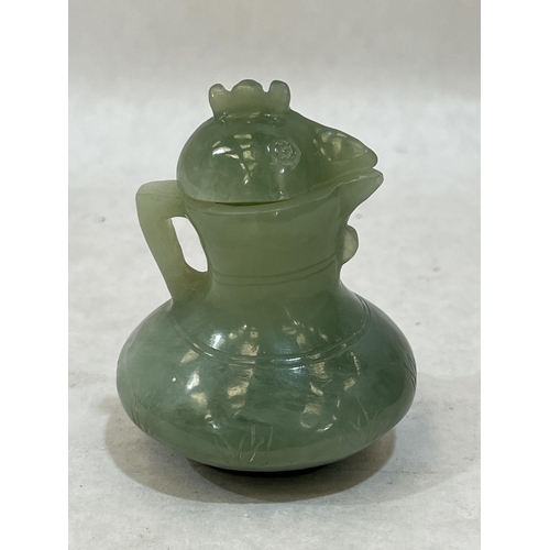 102A - A Chinese green jade jug and cover, carved in the form of a cockerel. 3