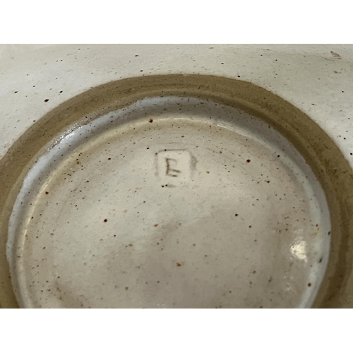 129 - * DAME LUCIE RIE, DBE. AUSTRIAN 1902-1995. A stoneware dish with pulled handle and pierced aperture ... 