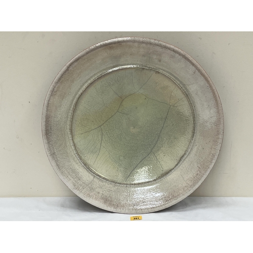 291 - * JOHN DUNN OF BRIGHTON. BRITISH Bn 1944. A studio raku pottery charger with lustrous lime green and... 