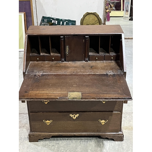 372 - An 18th Century oak bureau with fitted interior over three drawers on bracket feet. 30½