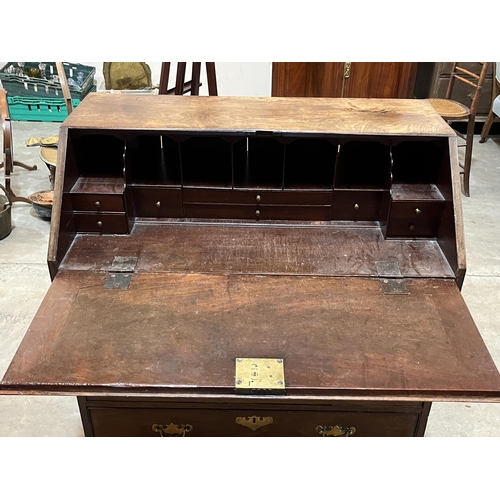 383 - A George III mahogany bureau with fitted interior, on later bracket feet. 36