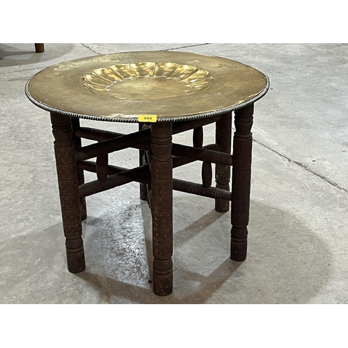 392 - An Indian folding table with brass benares tray top.