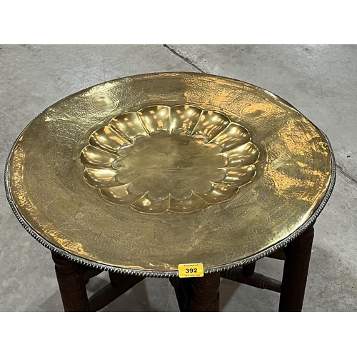 392 - An Indian folding table with brass benares tray top.