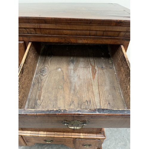 397 - A George II walnut chest on stand with two short over three long herringbone banded graduated drawer... 