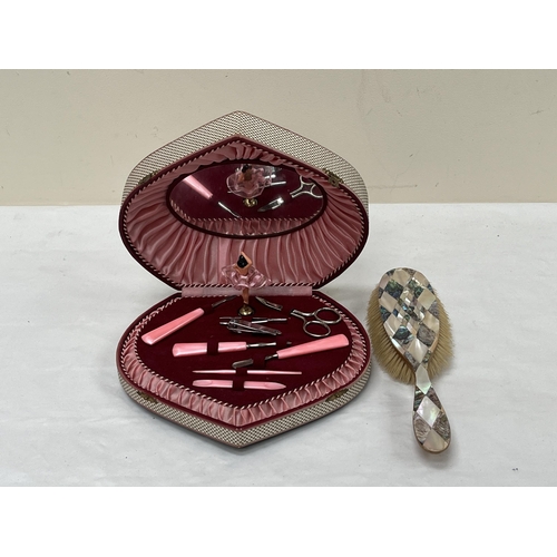 422 - A Lador musical vanity box and an abalone shell parquetry hair brush.