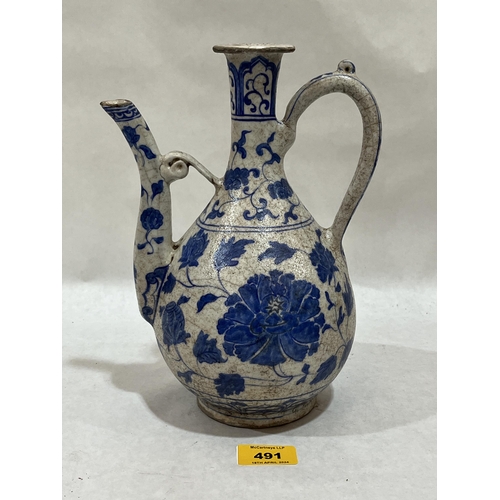 491 - A Turkish Ottoman blue and white decorated ewer, 9¾