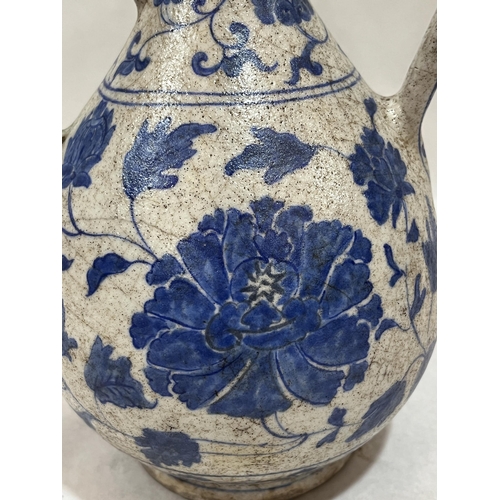 491 - A Turkish Ottoman blue and white decorated ewer, 9¾