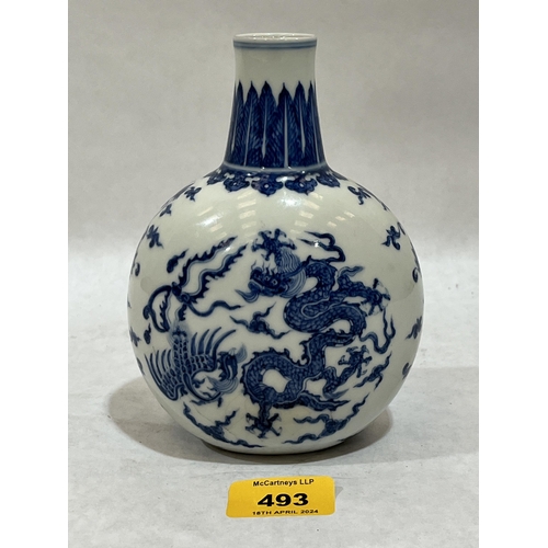 493 - A Chinese globular vase decorated in blue and white with dragons, birds and foliage. 6¼