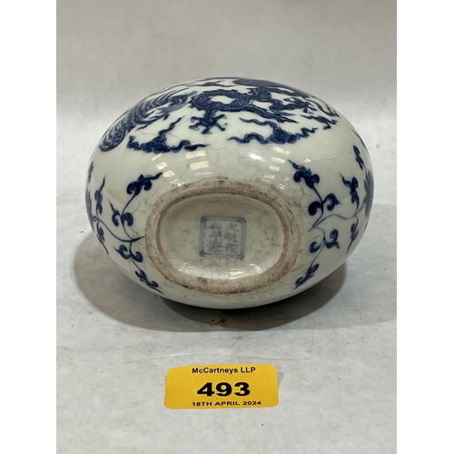 493 - A Chinese globular vase decorated in blue and white with dragons, birds and foliage. 6¼