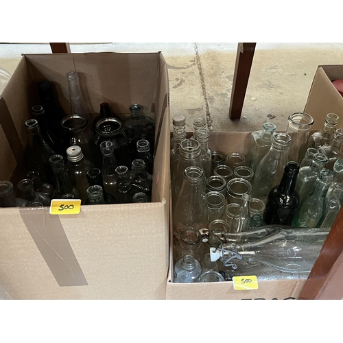 500 - A quantity of glass bottles and jars.