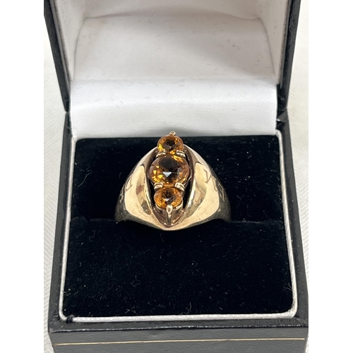 538 - A 9ct three stone topaz ring, 7.6g gross. Size S.