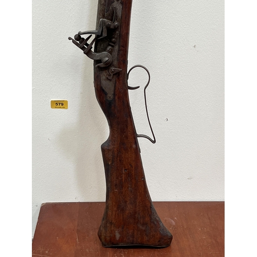 579 - An antique flintlock musket. 58½