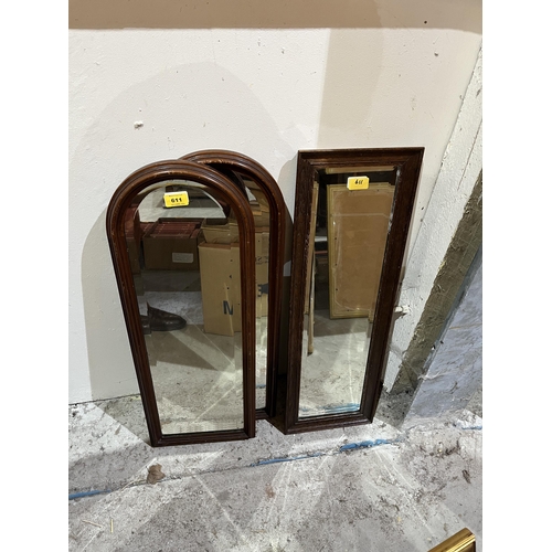 611 - A pair of mahogany arch framed mirrors and another with oak frame.