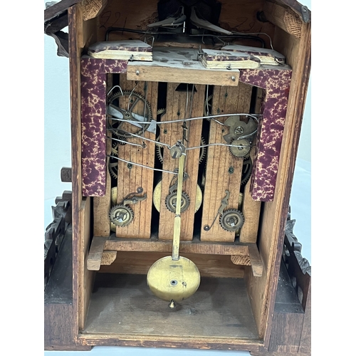 101 - A late 19th Century Bavarian quarter striking 'Cuckoo and Quail' table clock, in chalet style oak ca... 