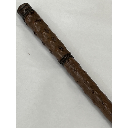 149 - A 19th Century walking cane with screw compartments for a glass bottle and drinking glass. 36