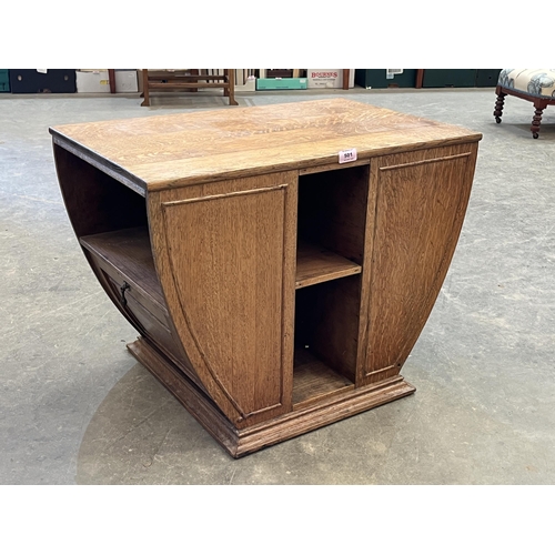 501 - An Art-Deco oak centre table fitted with two fall front music or magazine racks. 28