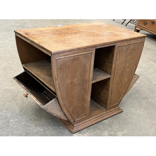 501 - An Art-Deco oak centre table fitted with two fall front music or magazine racks. 28