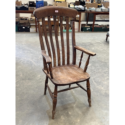 504 - A Victorian lath-back kitchen armchair.