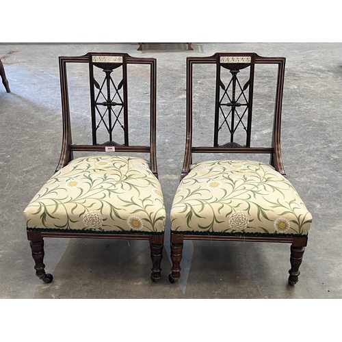 505 - A pair of late Victorian rosewood and bone inlaid salon chairs.