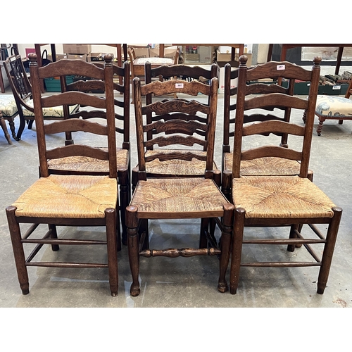 507 - A set of four and a pair of ladder back chairs with rush seats.