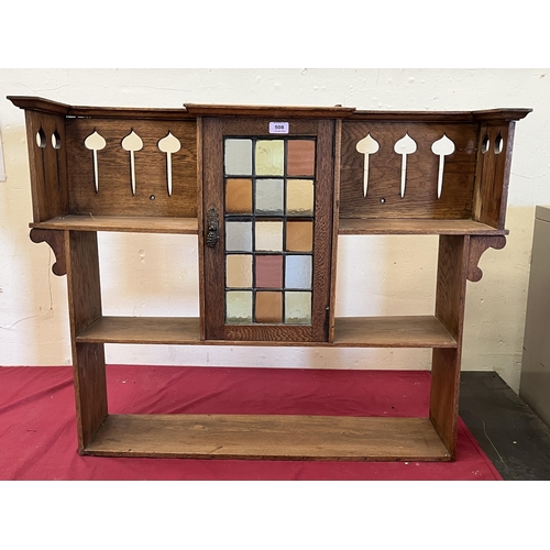 508 - A set of oak Arts and Crafts hanging wall shelves in the manner of Liberty and Co, with cupboard enc... 