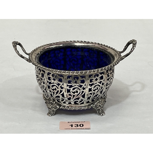 130 - A George V silver reticulated sucrier by Walker and Hall, with blue glass liner. Sheffield 1927. 6¼