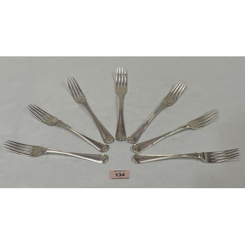 134 - Seven Georgian or William IV silver dinner forks. Various dates, crested, 16ozs.