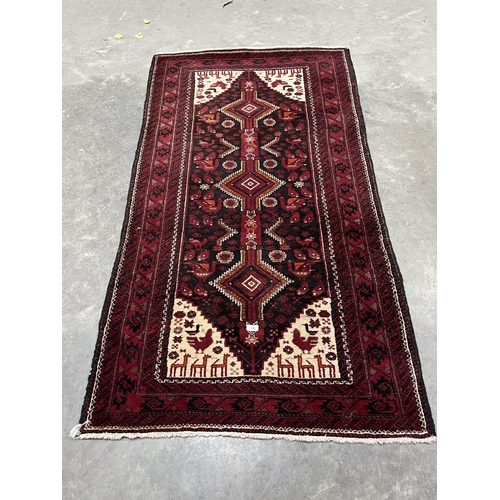 517 - A red ground eastern rug. 75