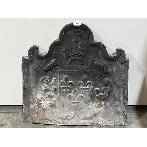 426 - An 18th Century cast iron fire back with armorial. 23