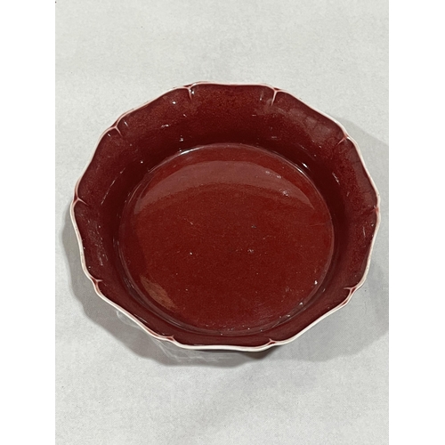 102 - A Chinese sang-de-boeuf bowl on wood stand. 7½