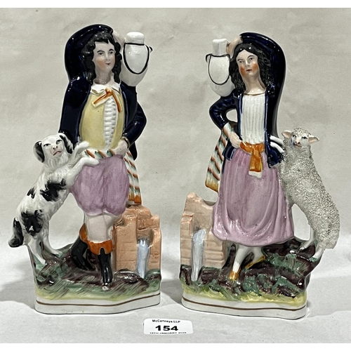 154 - A pair of 19th Century Staffordshire figure groups of man with dog and female companion with sheep. ... 