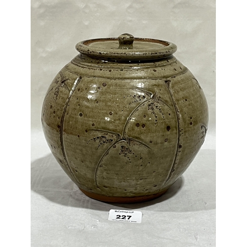 227 - PHIL ROGERS. BRITISH 1951-2020. A stoneware ovoid jar and cover. Sgraffito decorated on  a green gla... 