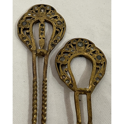 308 - A pair of yellow metal hairpins set with old cut white stones. 5¼